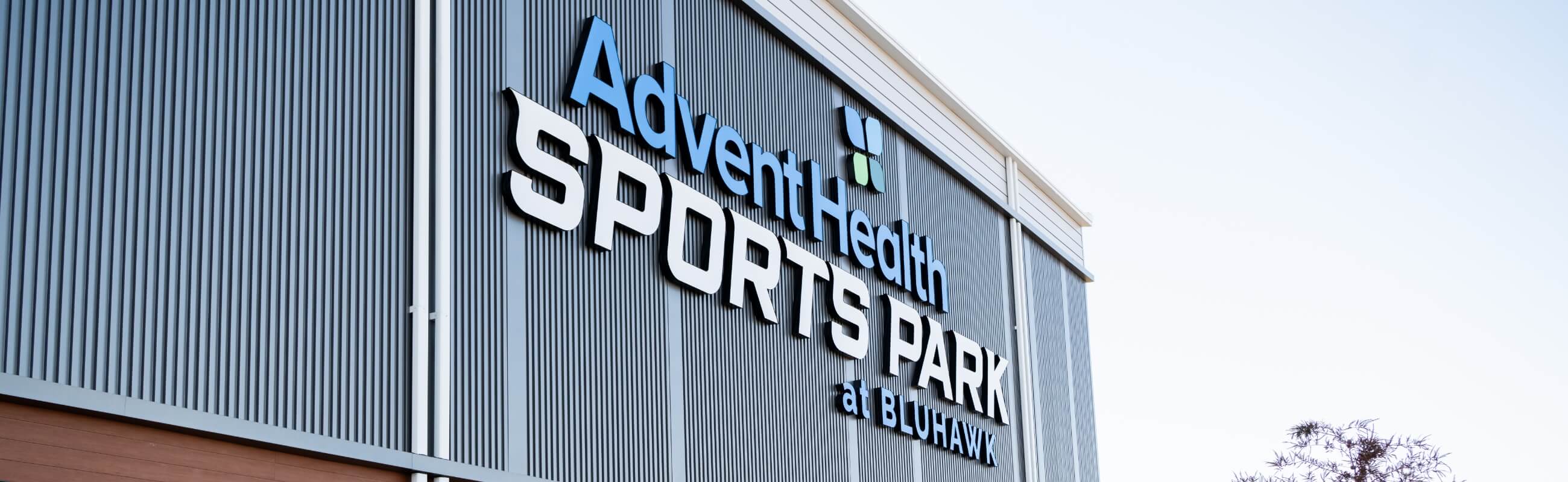 Family walking outside Advent Health Sports Park entrance